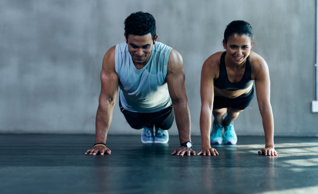 Shot of an attractive young couple working out together at the gym